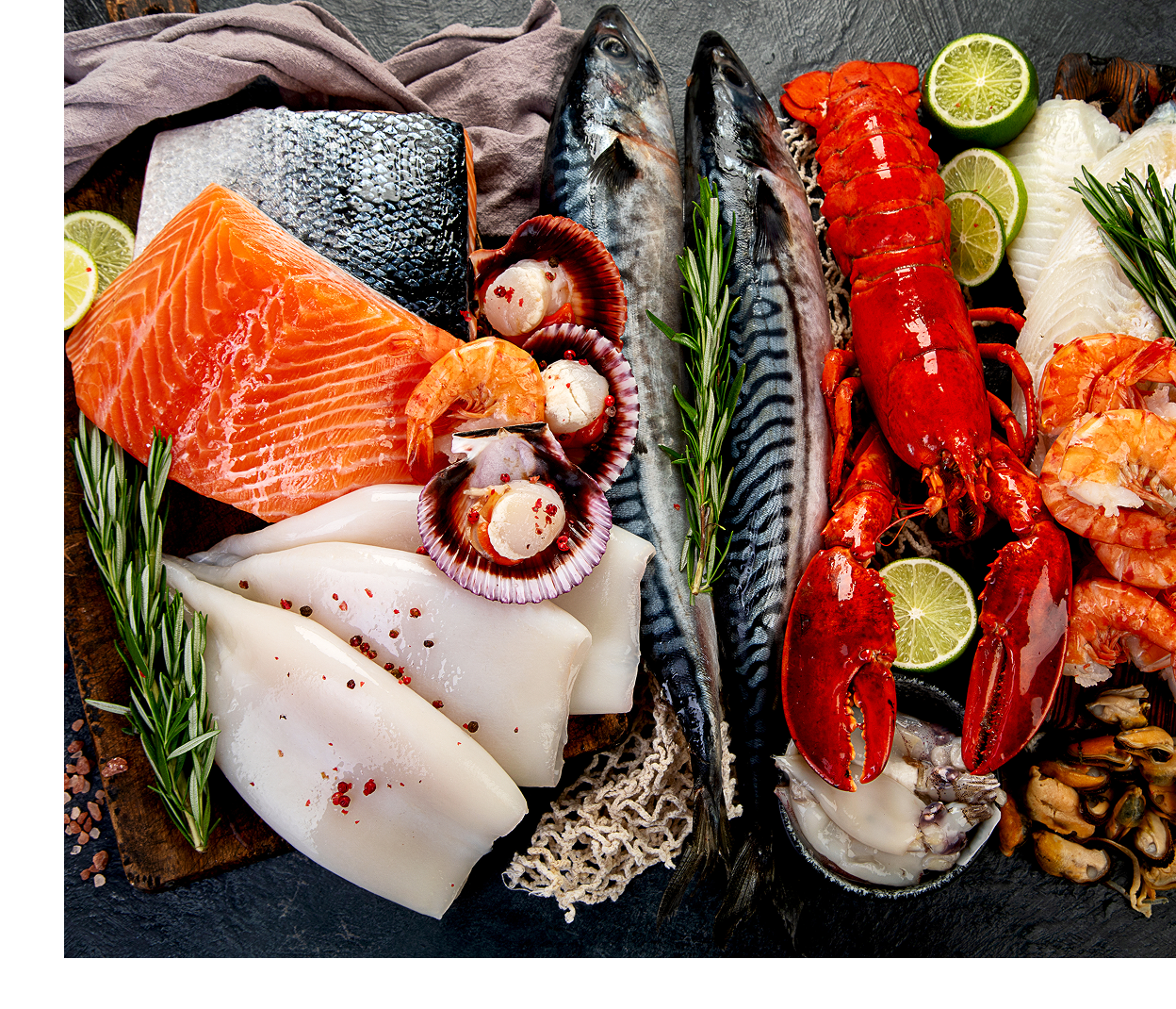 Assorted seafood with herbs and lime slices.