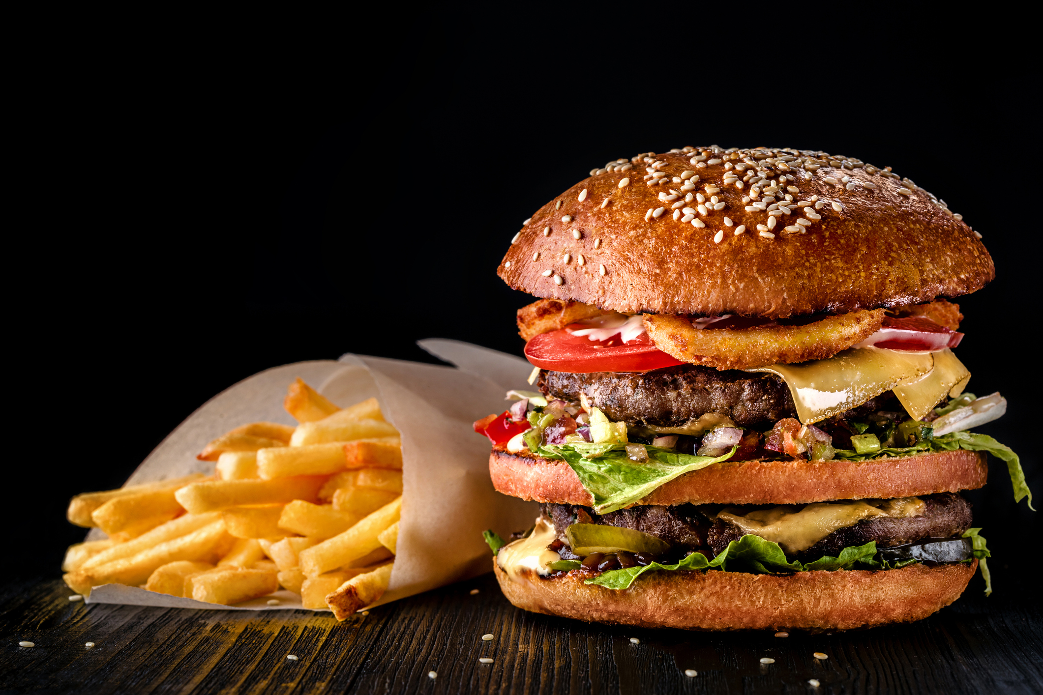 Delicious cheeseburger with fresh vegetables and fries.